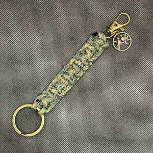 Green/Brown/Black Camouflage colored Paracord keychain with clip and charm.